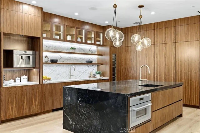 a large kitchen with stainless steel appliances lots of counter top space