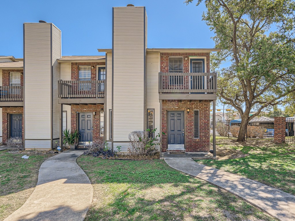 1841 River Crossing Circle, Unit E Austin, TX 78741 - Photo 1 of 1 a front view of house with yard