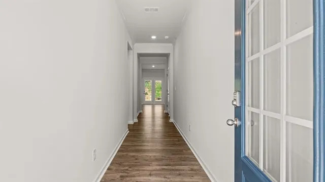 a view of a hallway with the wooden floor
