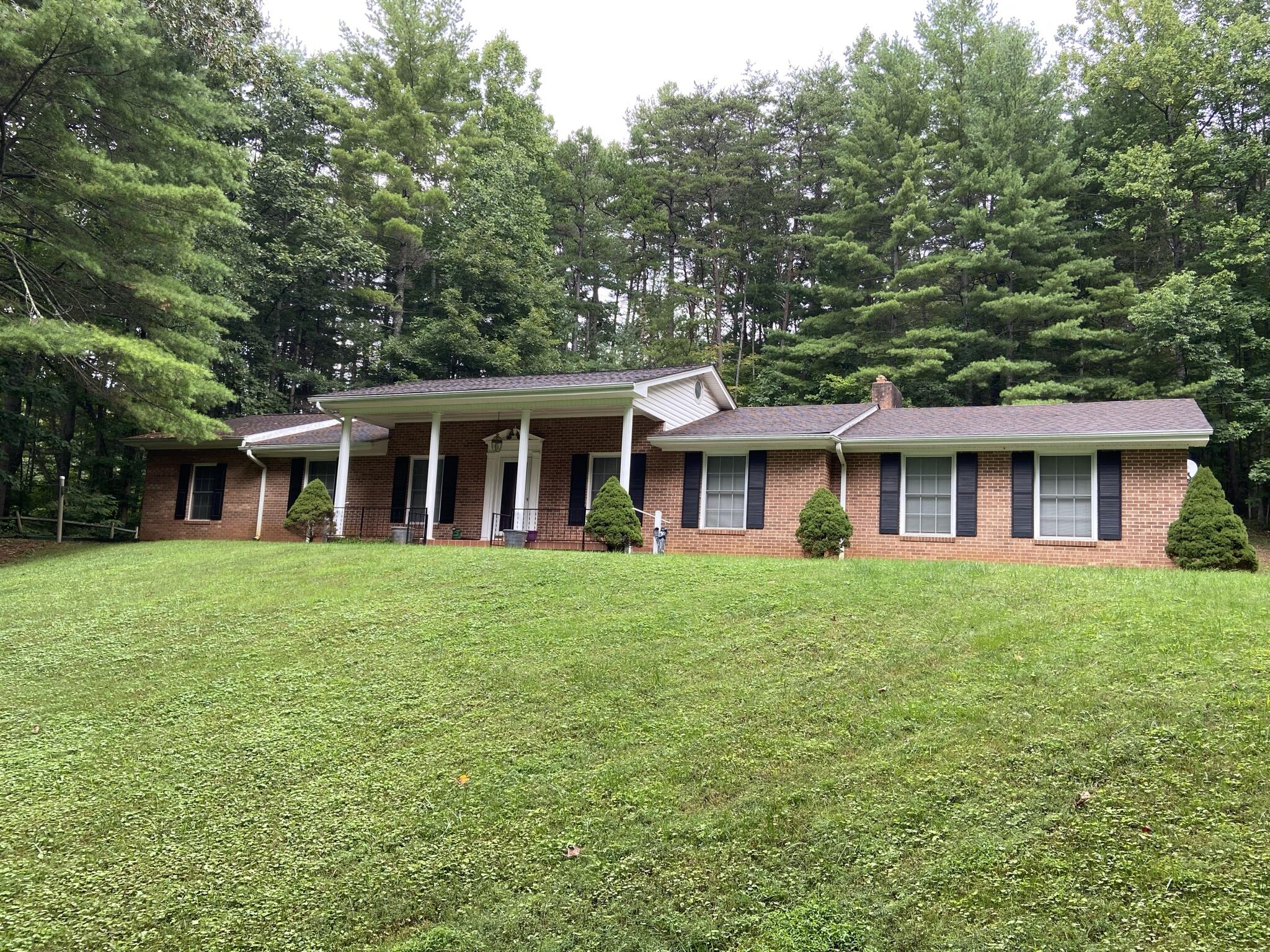 5378 Ferrum Mountain Road Callaway, VA 24067 - Photo 1 of 71 a view of a house with a yard and large trees