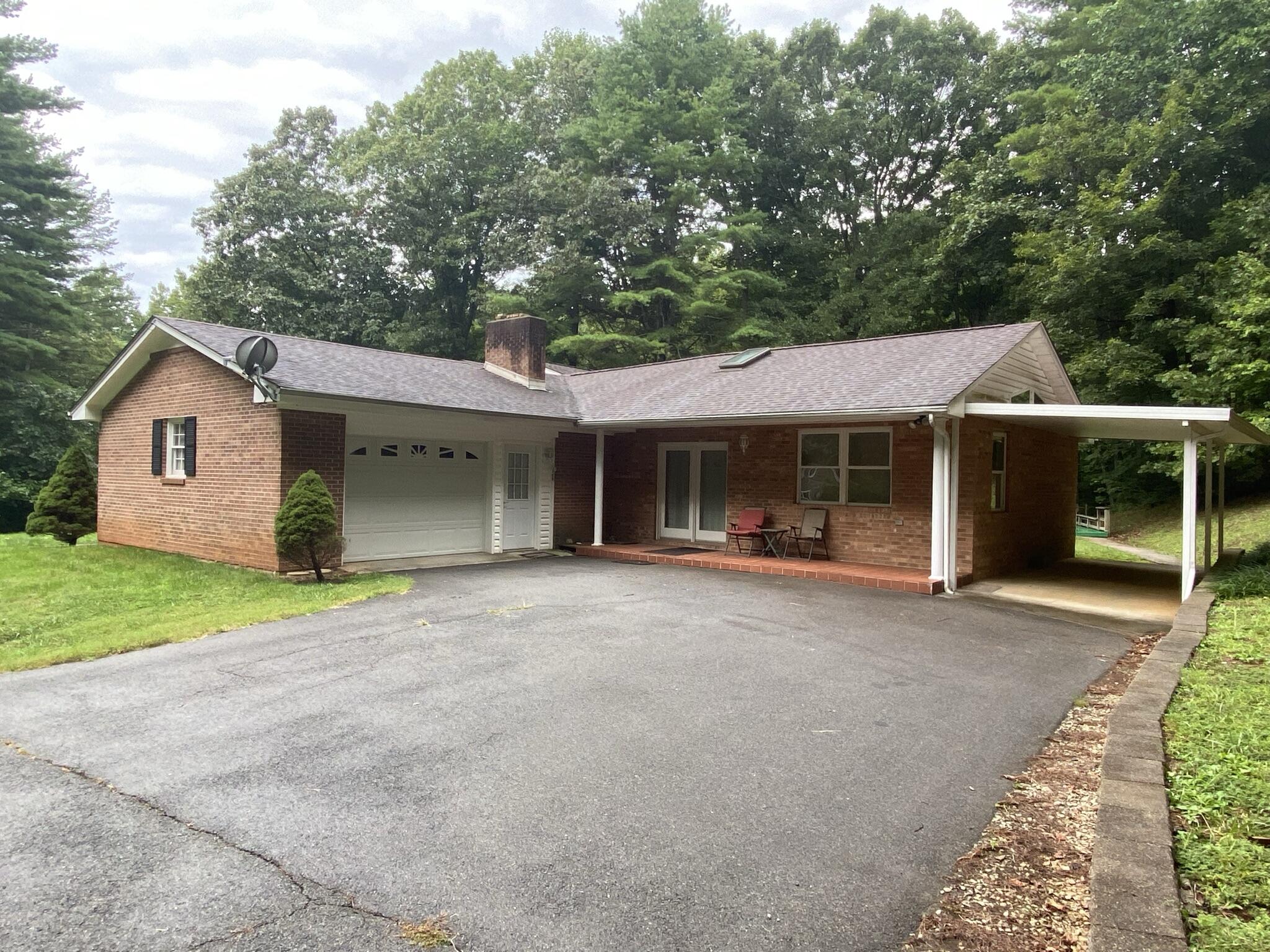 5378 Ferrum Mountain Road Callaway, VA 24067 - Photo 2 of 71 a front view of a house with a garden and trees