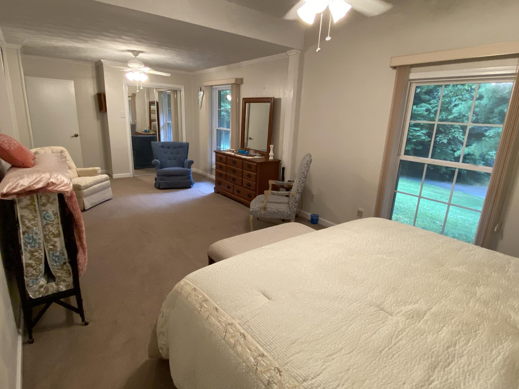 5378 Ferrum Mountain Road Callaway, VA 24067 - Photo 17 of 71 a bedroom with a bed and a chandelier