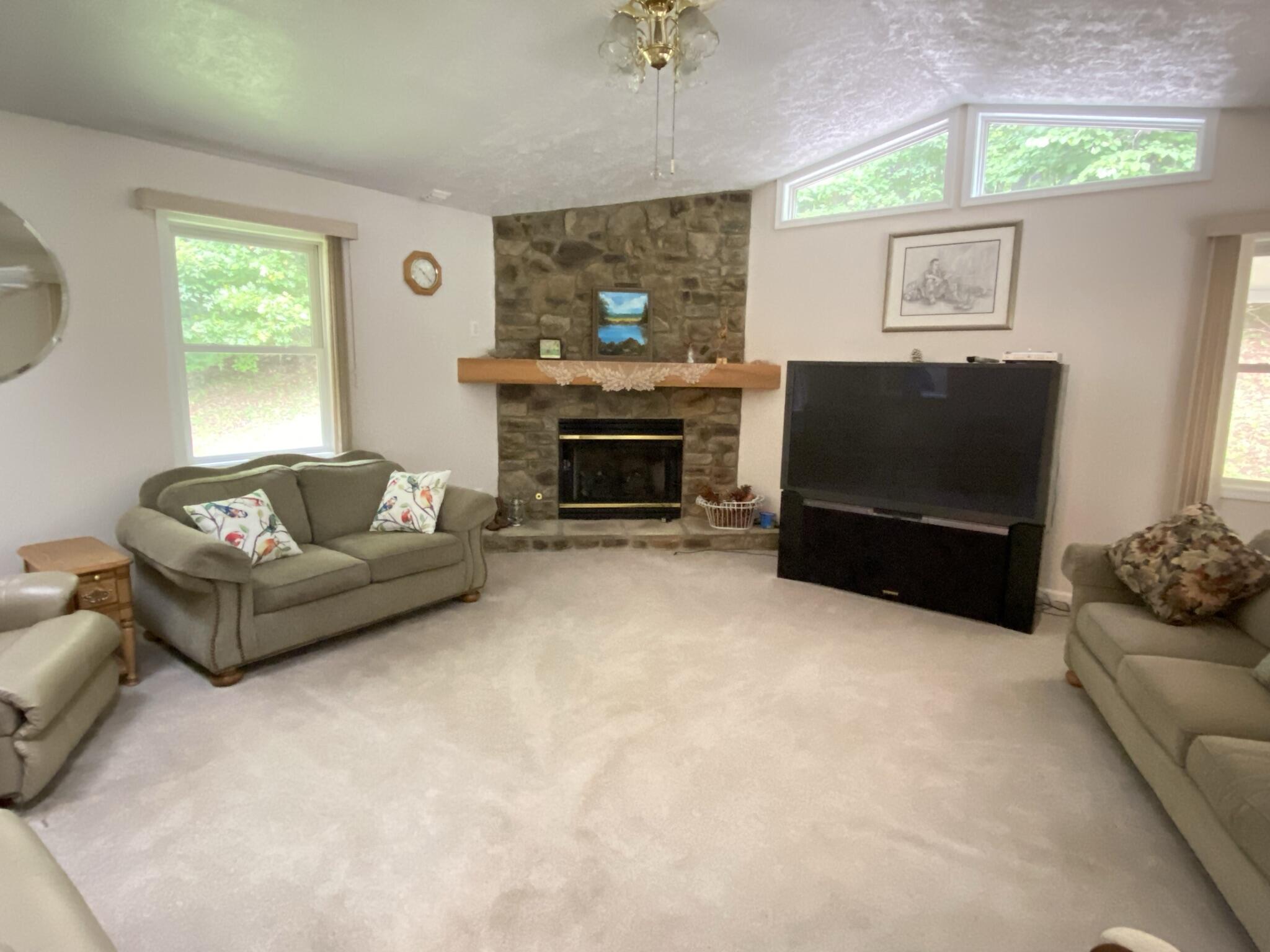 5378 Ferrum Mountain Road Callaway, VA 24067 - Photo 38 of 71 a living room with furniture a flat screen tv and a fireplace