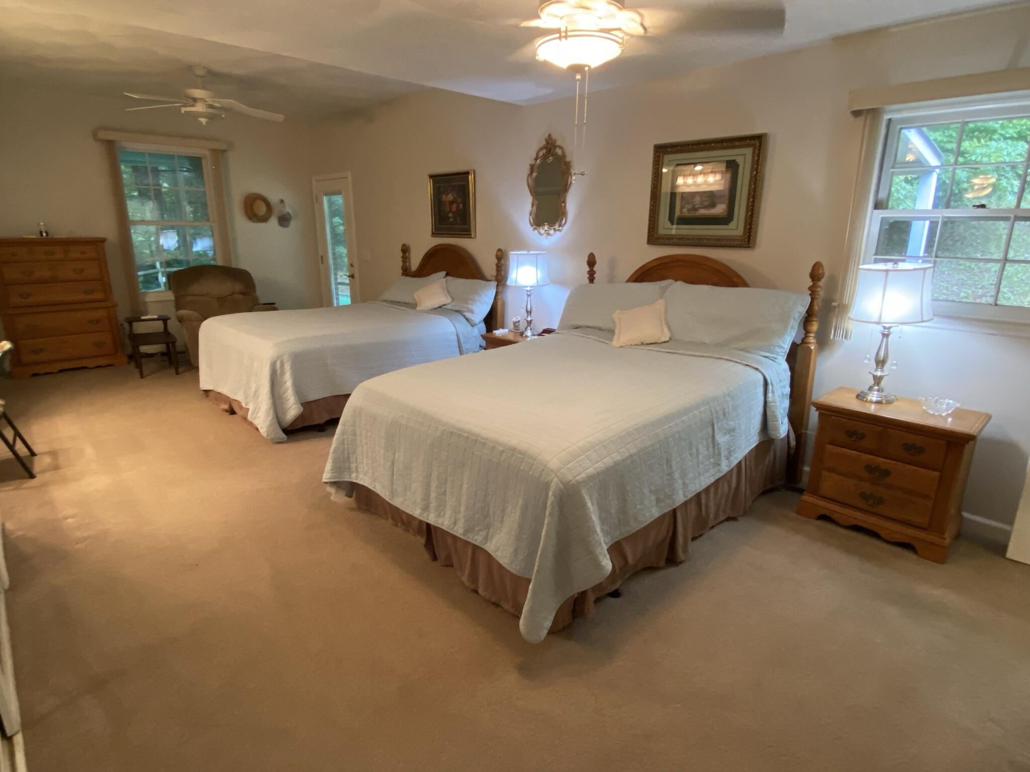 5378 Ferrum Mountain Road Callaway, VA 24067 - Photo 46 of 71 a bedroom with two beds and a chandelier