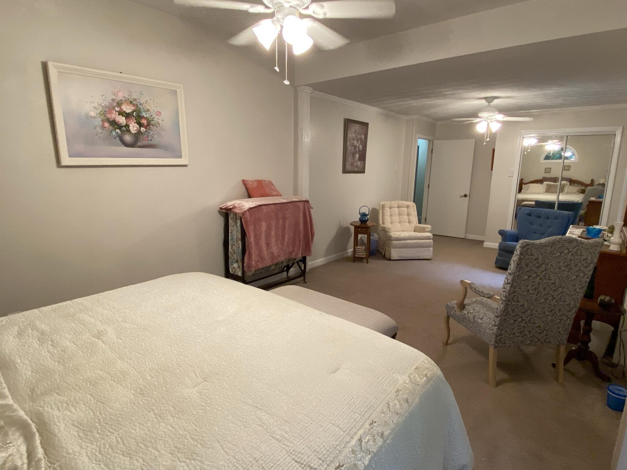 5378 Ferrum Mountain Road Callaway, VA 24067 - Photo 50 of 71 a bedroom with a bed and a chandelier