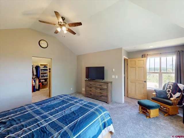 a bedroom with furniture and a flat screen tv