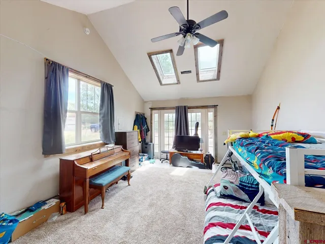 a living room with furniture a flat screen tv and a window