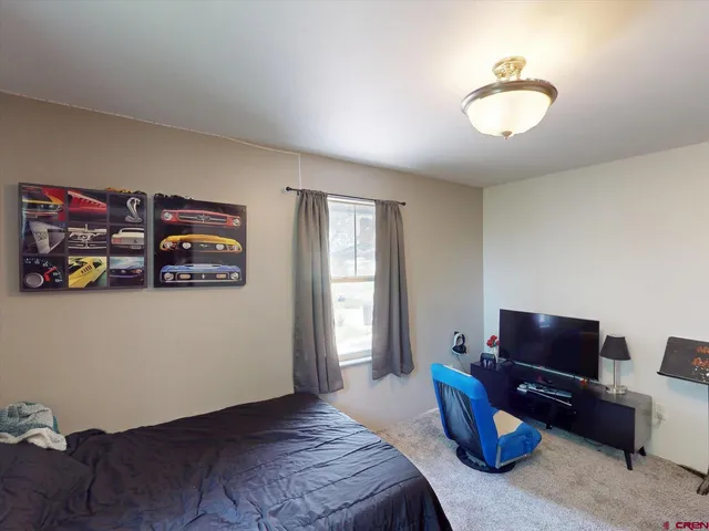 a bedroom with bed and a chandelier