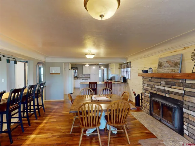 a view of a dining room with furniture and chandelier