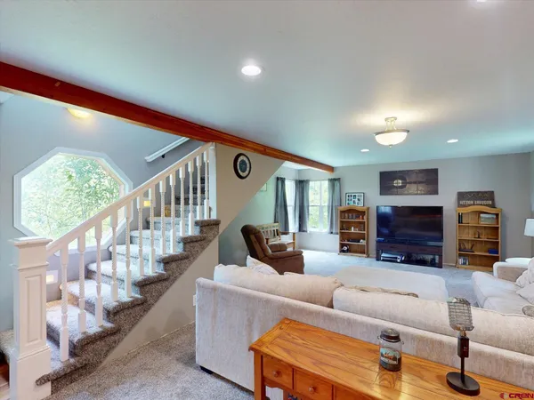 a living room with furniture fireplace and a flat screen tv