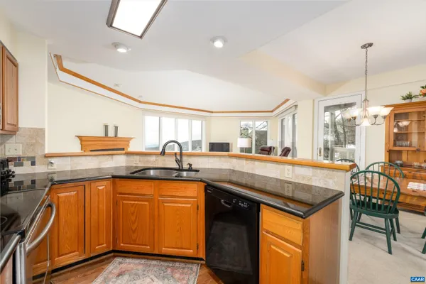 a kitchen with a sink a stove and cabinets