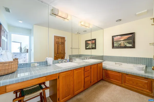 a bathroom with a granite countertop sink and a shower
