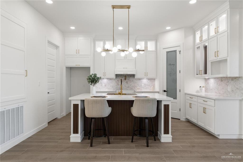 505 Freedom Way Weslaco, TX 78596 - Photo 5 of 20 a kitchen with center island table and chairs