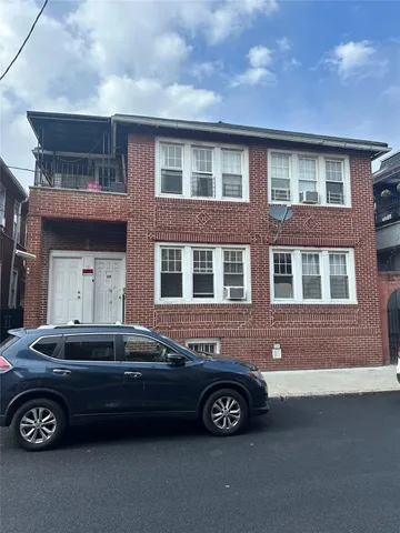 a front view of a house with parking space