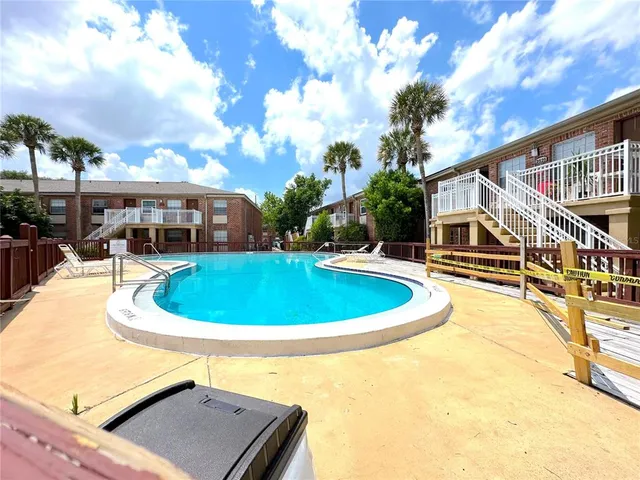 a view of a swimming pool with an outdoor seating
