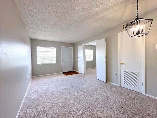 an empty room with a empty space and windows