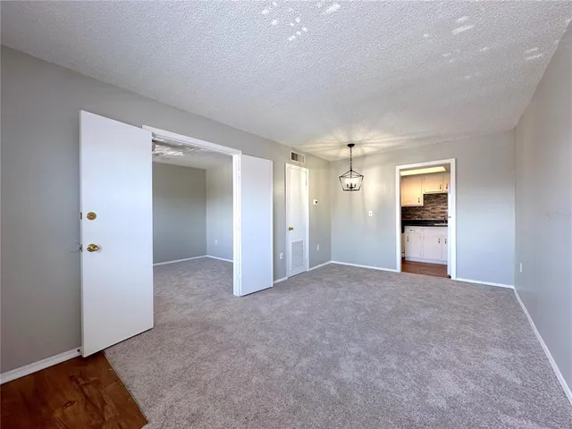 an empty room with an entryway and a livingroom