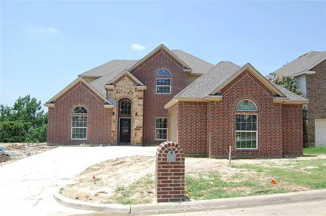 a view of a brick house with large windows