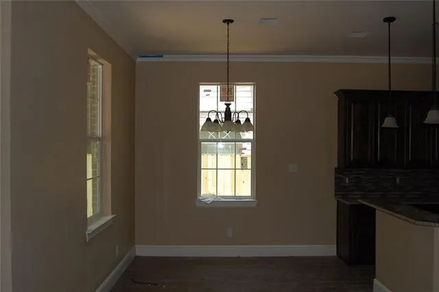 a kitchen with window and cabinets