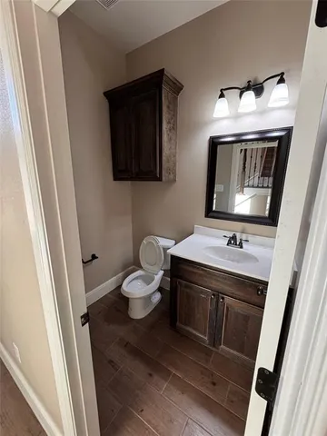 a bathroom with a sink toilet and mirror