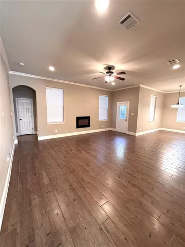 a view of a livingroom with kitchen and a stove
