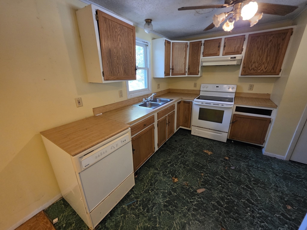 71 Wendell Street Athol, MA 01331 - Photo 7 of 12 a kitchen with a stove and a microwave