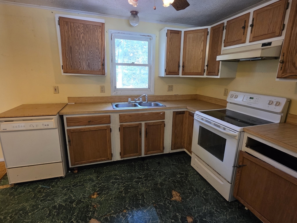 71 Wendell Street Athol, MA 01331 - Photo 8 of 12 a kitchen with stainless steel appliances a stove a sink and a microwave