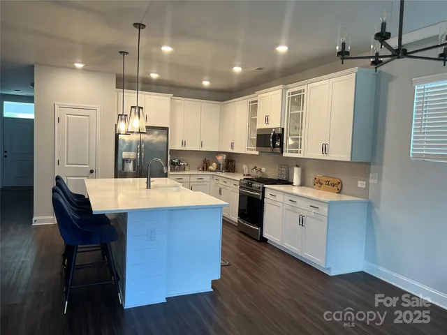 a kitchen with a sink appliances and cabinets