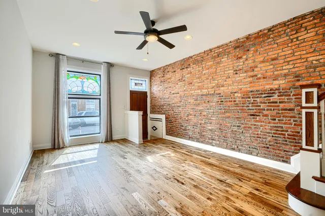 a view of livingroom with hardwood floor and a ceiling fan