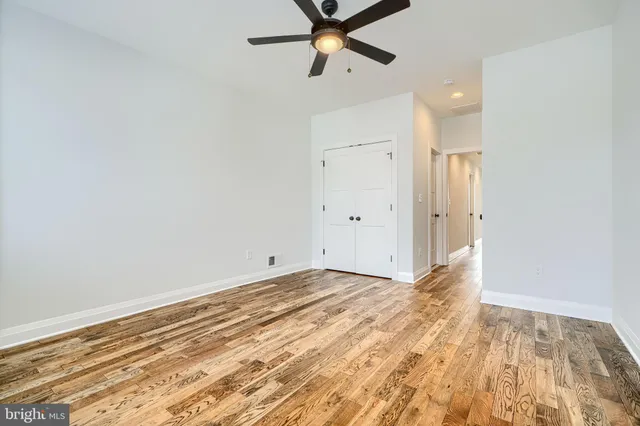 a view of a room with a sink and wooden floor
