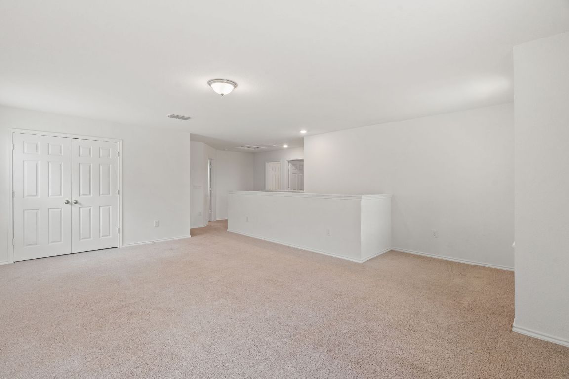 7808 Lawford Way Austin, TX 78744 - Photo 27 of 40 Unfurnished living room with light colored carpet
