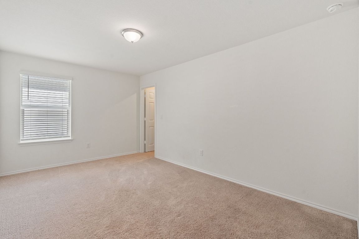 7808 Lawford Way Austin, TX 78744 - Photo 28 of 40 Unfurnished room with carpet and baseboards