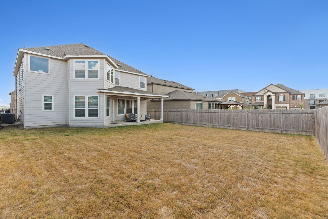 7808 Lawford Way Austin, TX 78744 - Photo 31 of 40 Back of property featuring a patio area, a fenced backyard, and roof with shingles