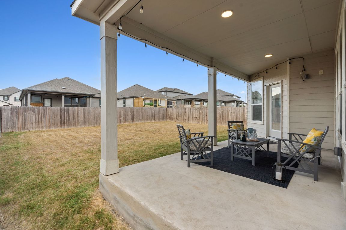 7808 Lawford Way Austin, TX 78744 - Photo 32 of 40 Fenced backyard with a patio area and a residential view
