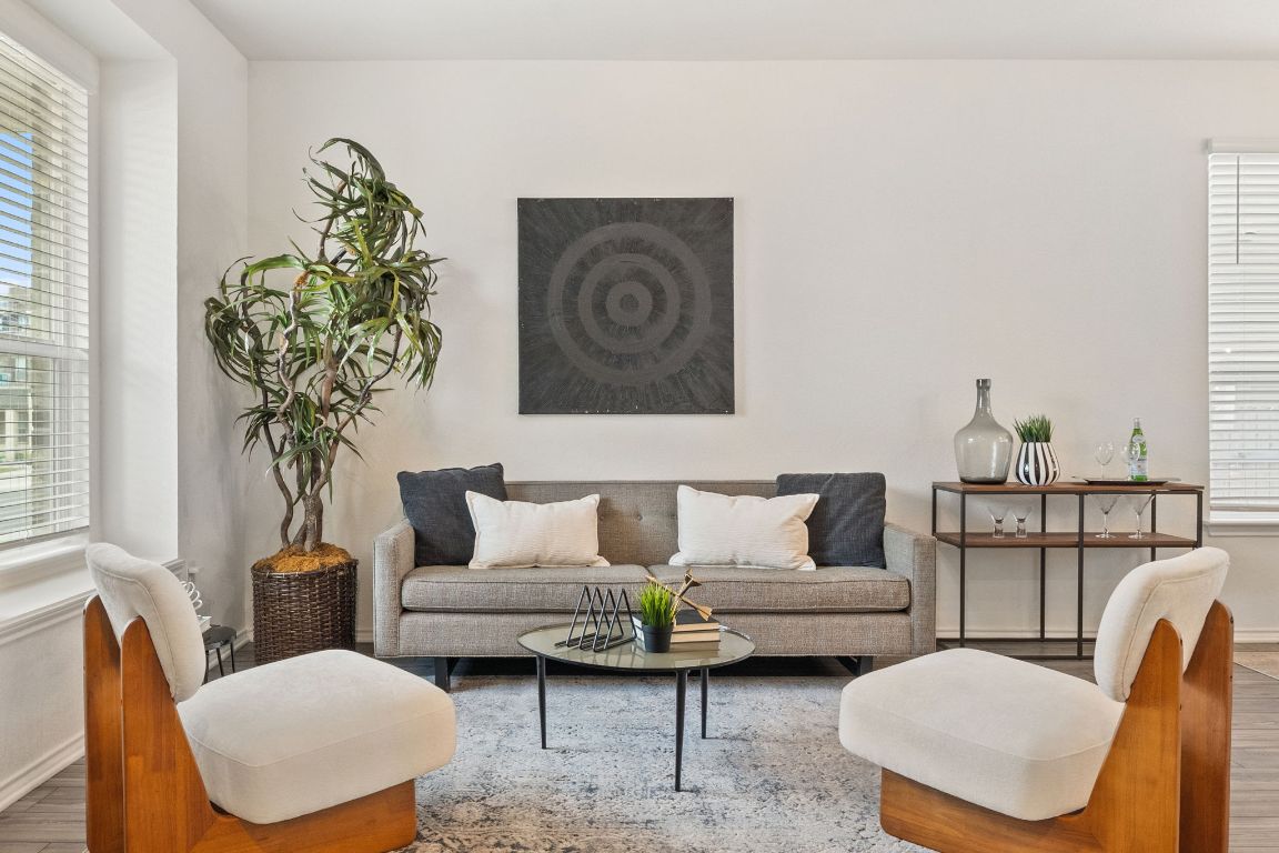 7808 Lawford Way Austin, TX 78744 - Photo 5 of 40 Living area with wood finished floors and healthy amount of natural light