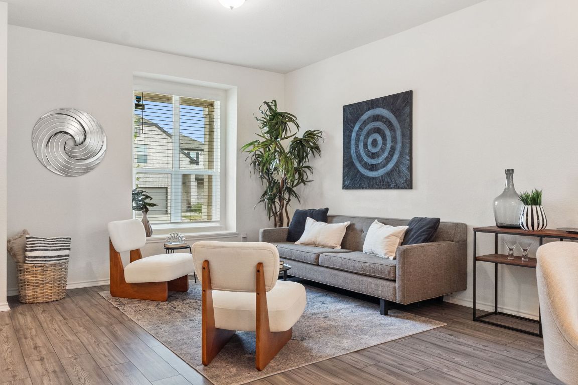 7808 Lawford Way Austin, TX 78744 - Photo 6 of 40 Living room featuring wood finished floors