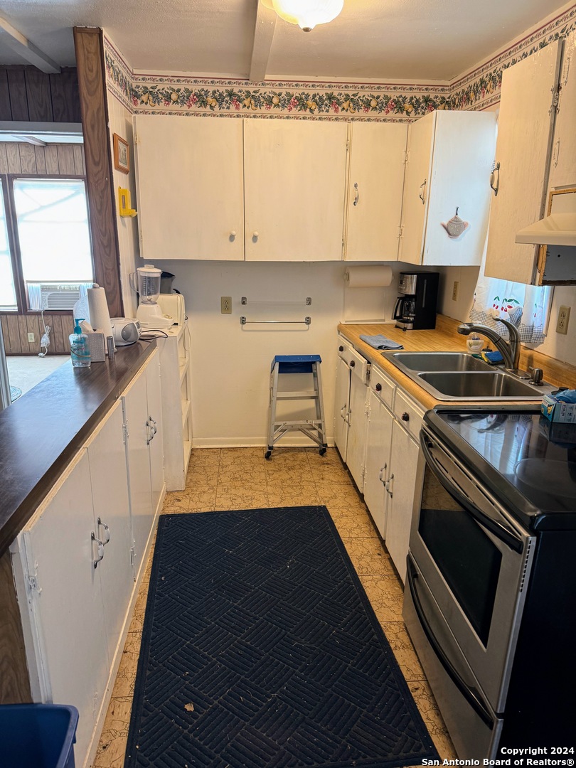 201 Cypress Bluff Road Pipe Creek, TX 78063 - Photo 12 of 16 a kitchen with a sink stove and cabinets