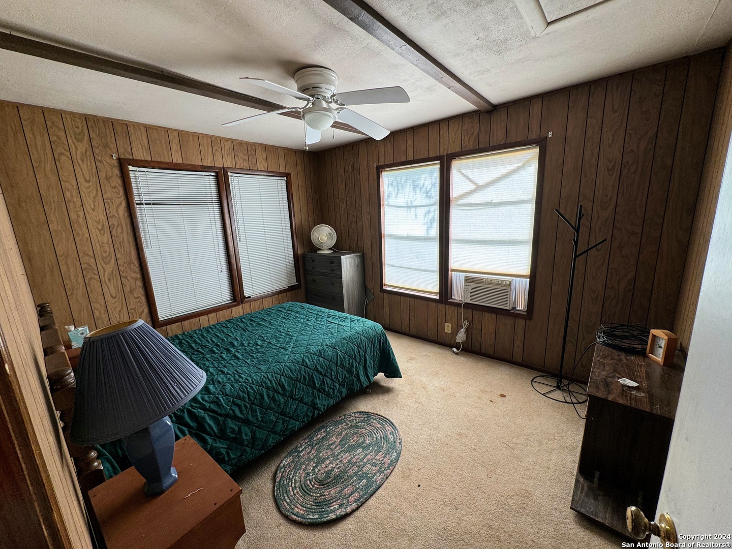 201 Cypress Bluff Road Pipe Creek, TX 78063 - Photo 13 of 16 a bedroom with a bed window and a chandelier