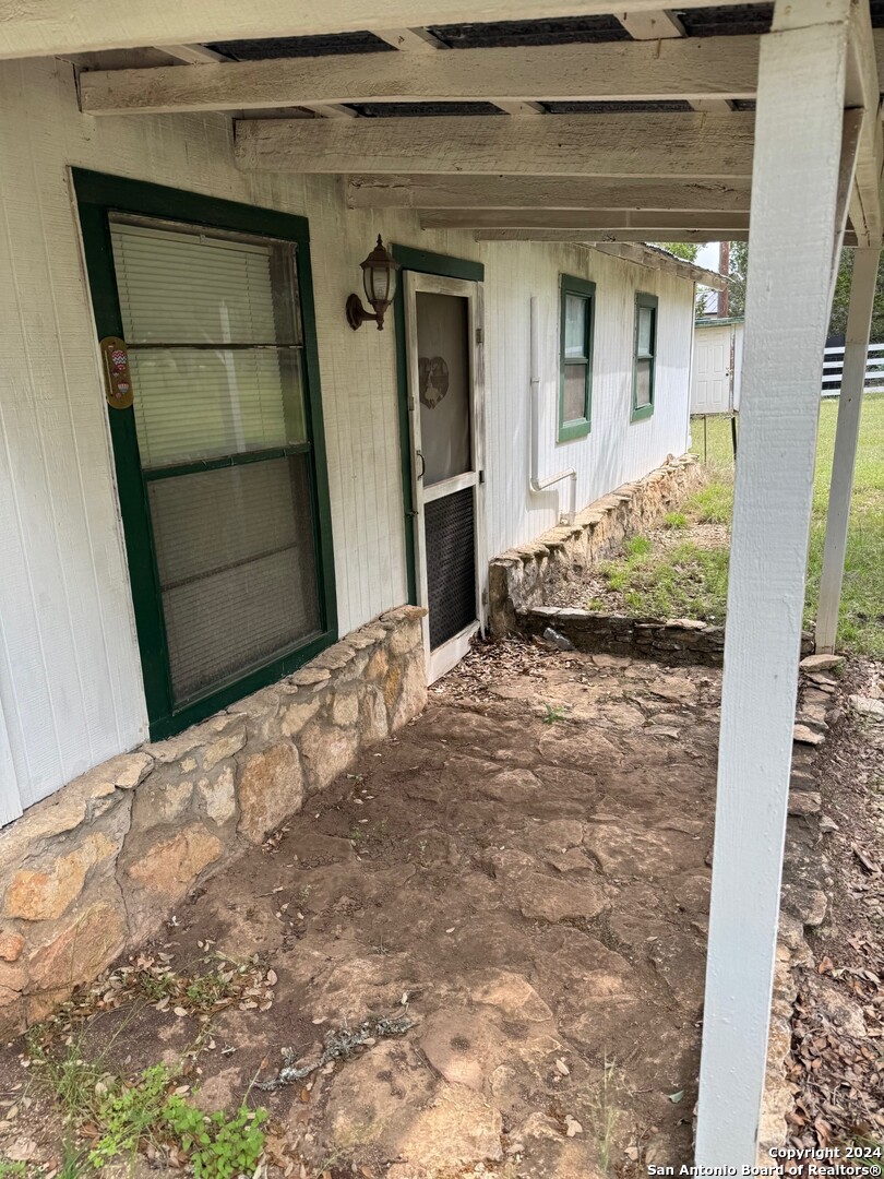 201 Cypress Bluff Road Pipe Creek, TX 78063 - Photo 10 of 16 a view of yellow house with a door