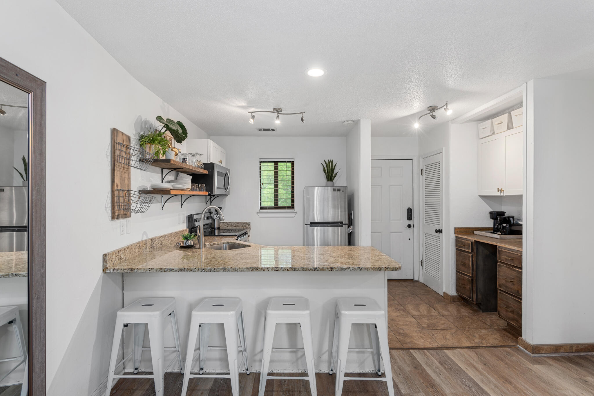 3605 East County Highway 30A, Unit 223 Santa Rosa Beach, FL 32459 - Photo 11 of 30 a kitchen with kitchen island granite countertop a sink cabinets and stainless steel appliances