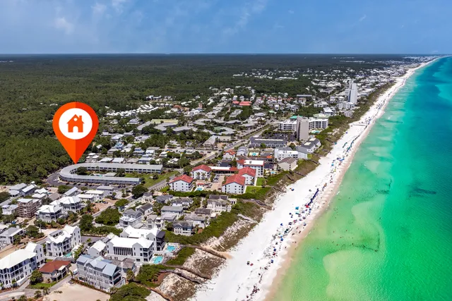 a front view of a house with a yard and potted plants