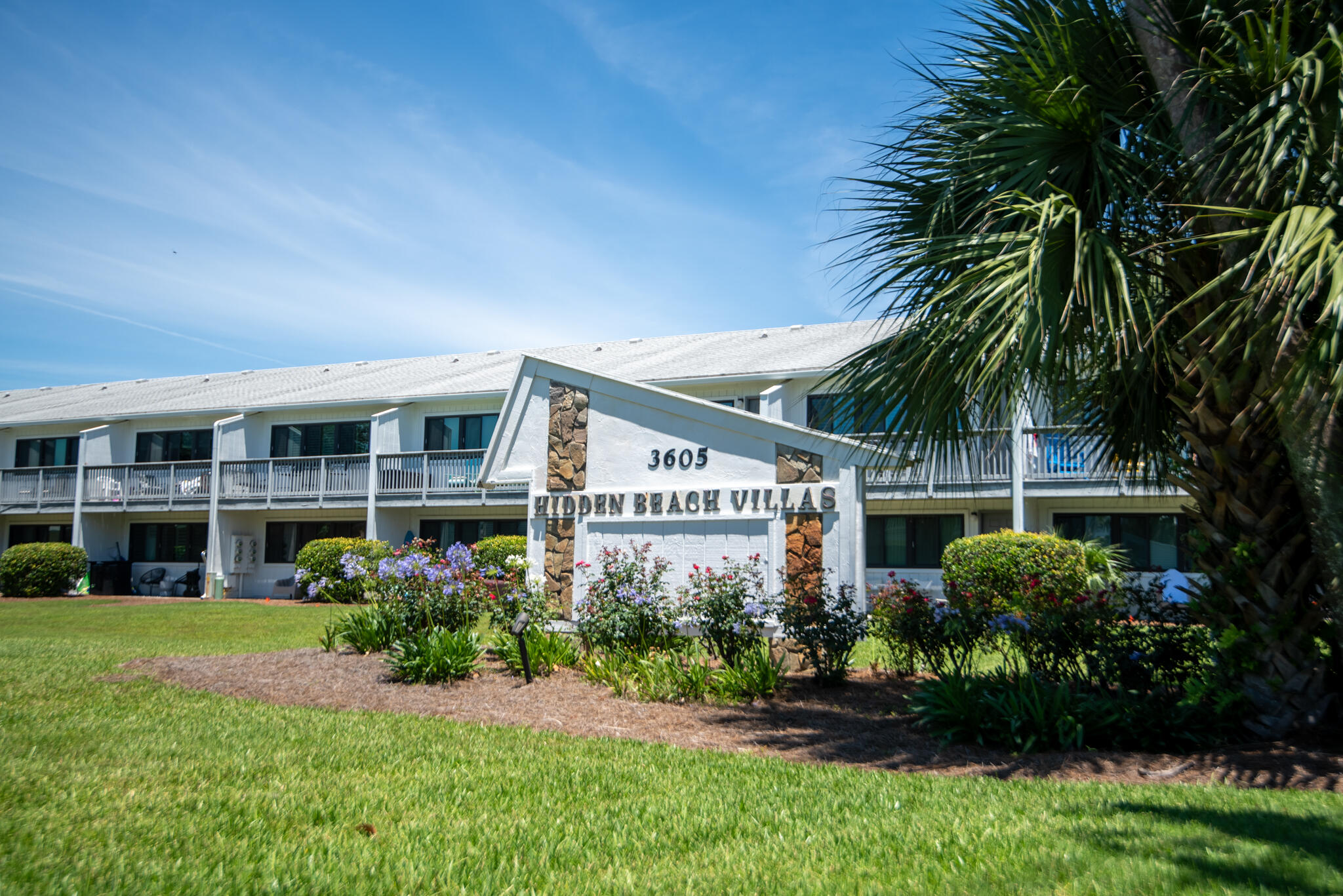 3605 East County Highway 30A, Unit 223 Santa Rosa Beach, FL 32459 - Photo 29 of 30 a front view of a house with a yard and potted plants