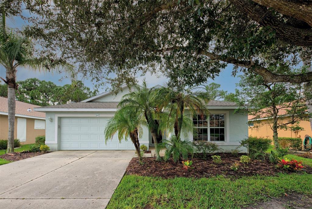 2177 Boxwood Street North Port, FL 34289 - Photo 1 of 1 a front view of a house with garden