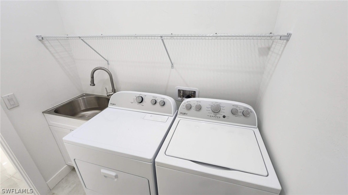 810 Homestead Road South Lehigh Acres, FL 33974 - Photo 16 of 18 a utility room with dryer and washer
