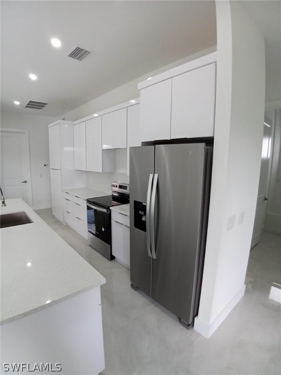 810 Homestead Road South Lehigh Acres, FL 33974 - Photo 5 of 18 a kitchen with a refrigerator and a sink