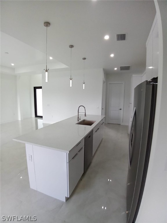 810 Homestead Road South Lehigh Acres, FL 33974 - Photo 6 of 18 a large kitchen with a sink a refrigerator and a dishwasher