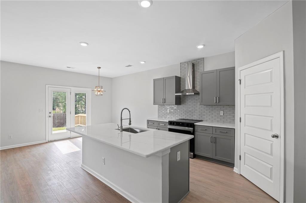 3650 River Rock Road Lithonia, GA 30038 - Photo 11 of 42 a kitchen with stainless steel appliances granite countertop a sink stove and refrigerator
