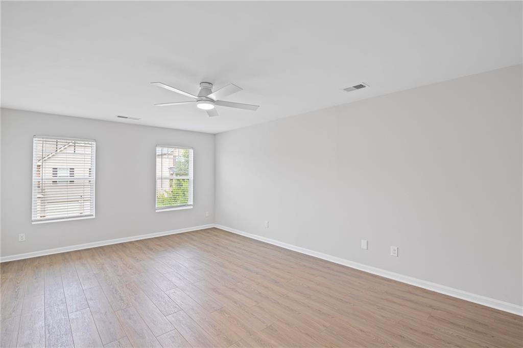 3650 River Rock Road Lithonia, GA 30038 - Photo 20 of 42 wooden floor in an empty room with a window