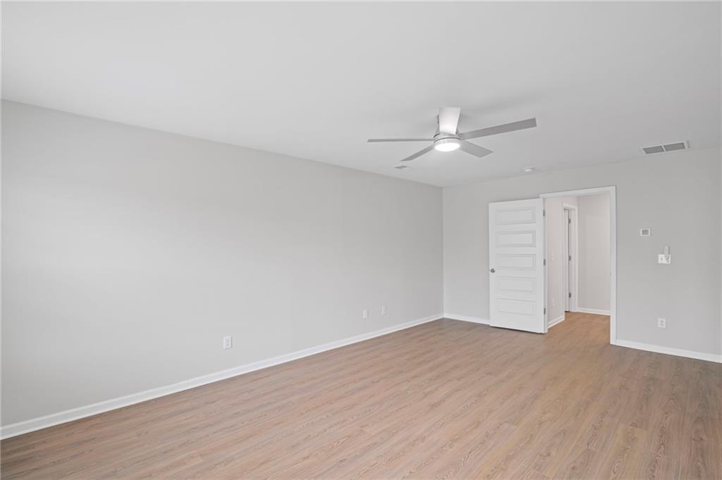 3650 River Rock Road Lithonia, GA 30038 - Photo 22 of 42 a view of an empty room with wooden floor