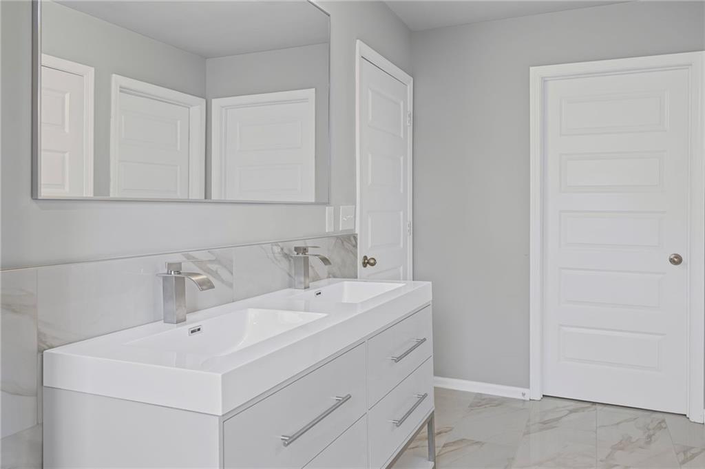 3650 River Rock Road Lithonia, GA 30038 - Photo 25 of 42 a bathroom with a sink and a mirror
